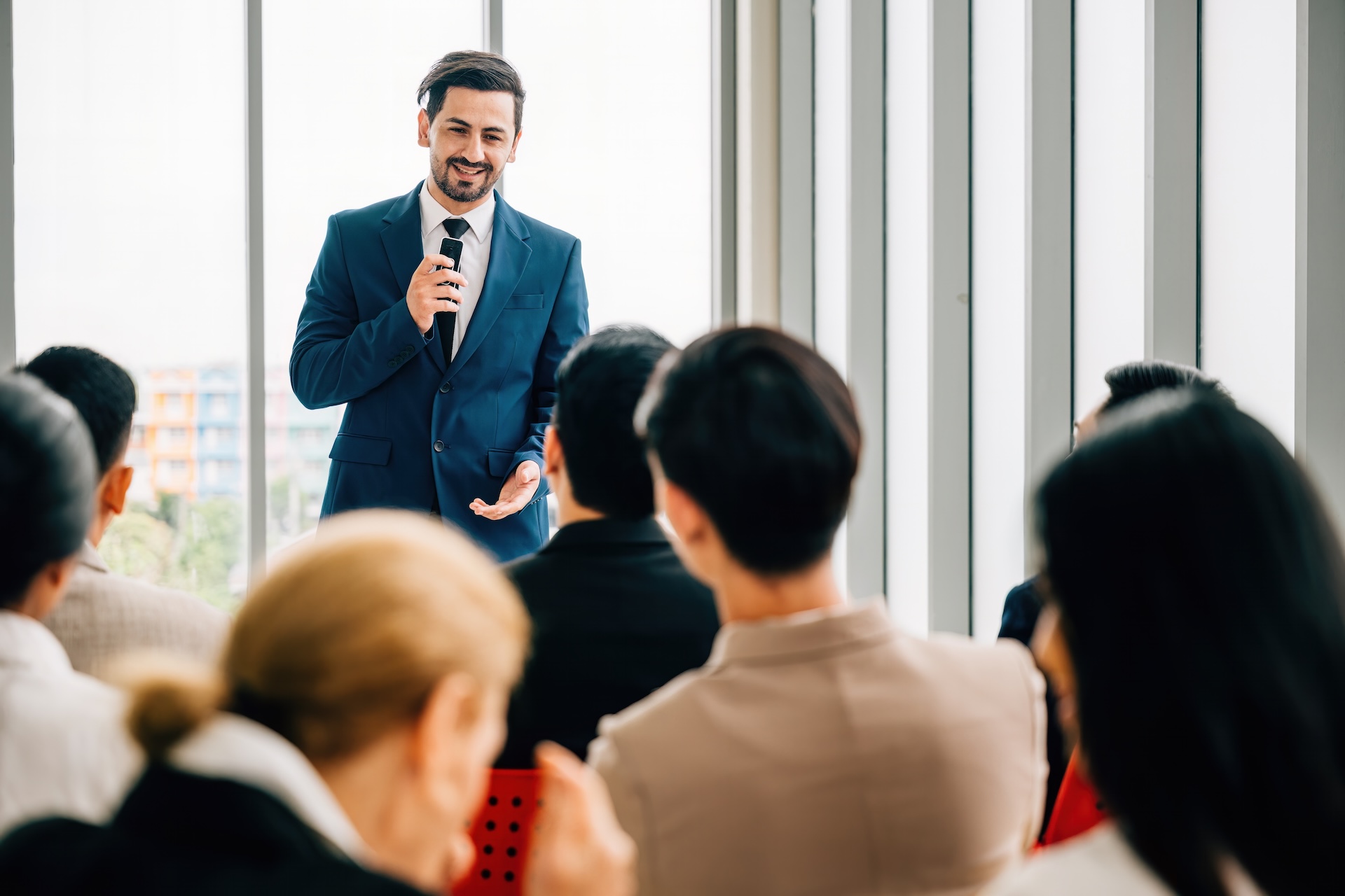 Singapore executive delivering a compelling public speaking presentation with visual aids